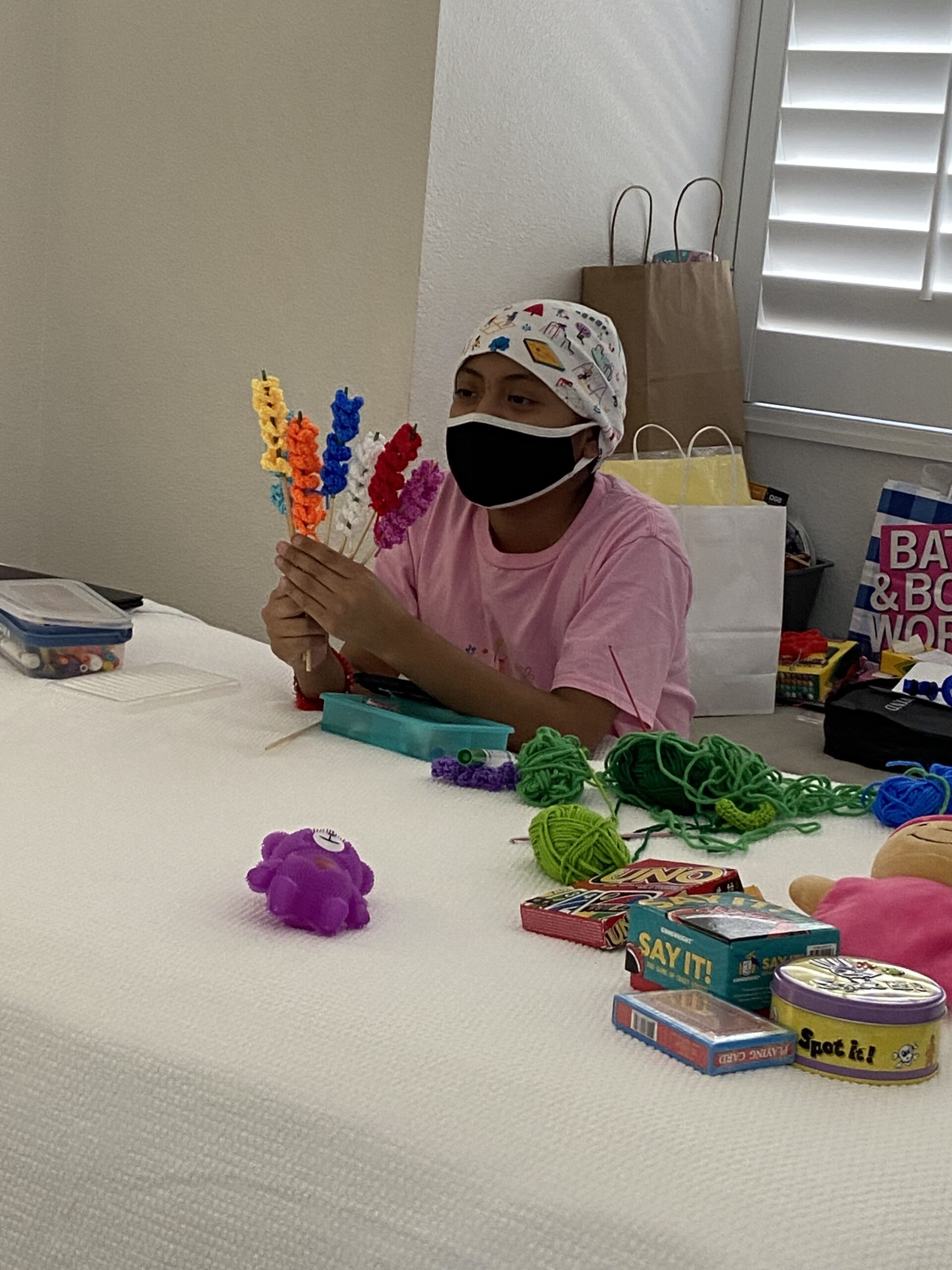 13-year-old Zaire with the crochet flowers she made.