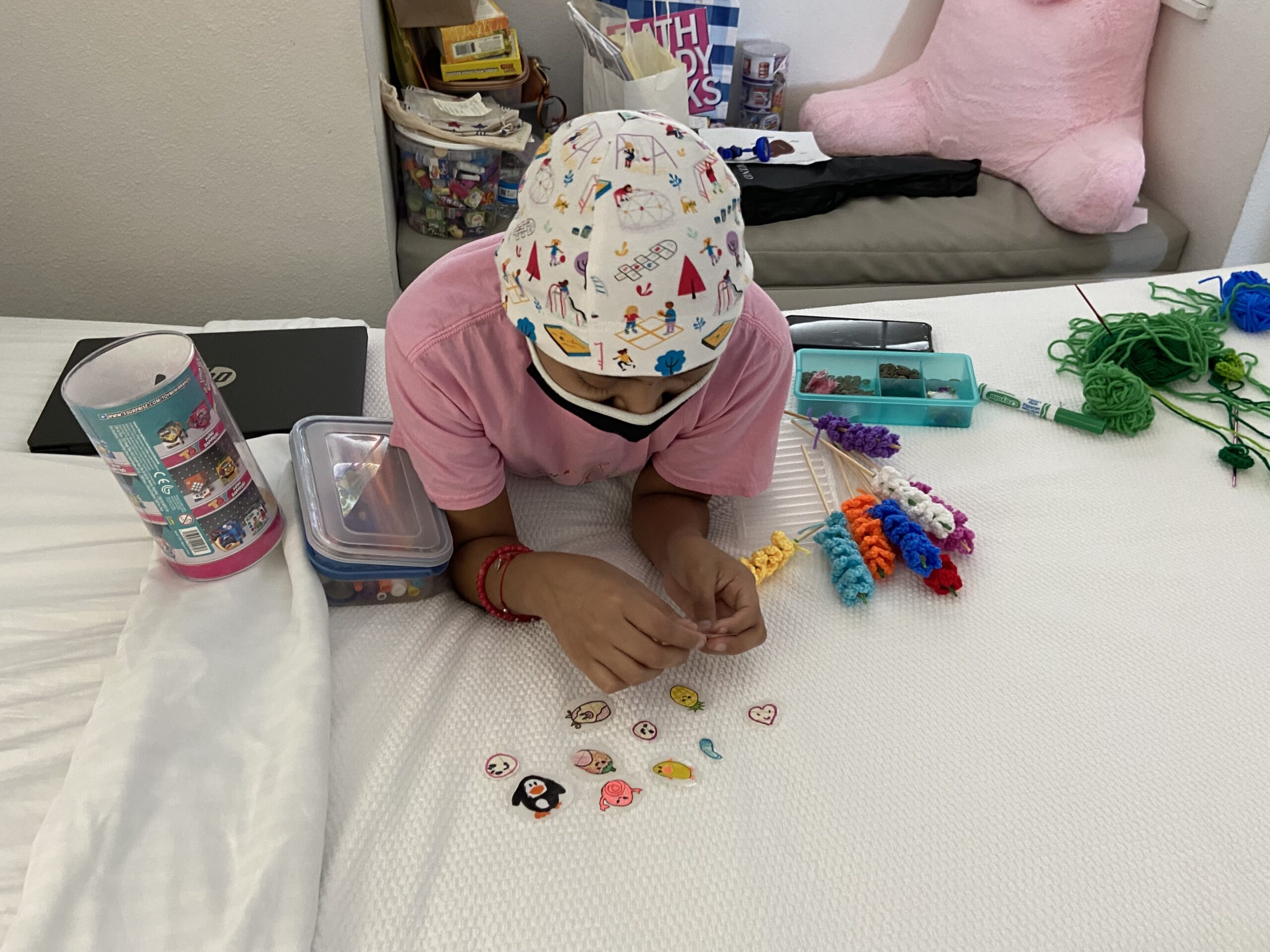13-year-old girl, Zaire, wearing a face mask and sharing the diy stickers and crafts she made 