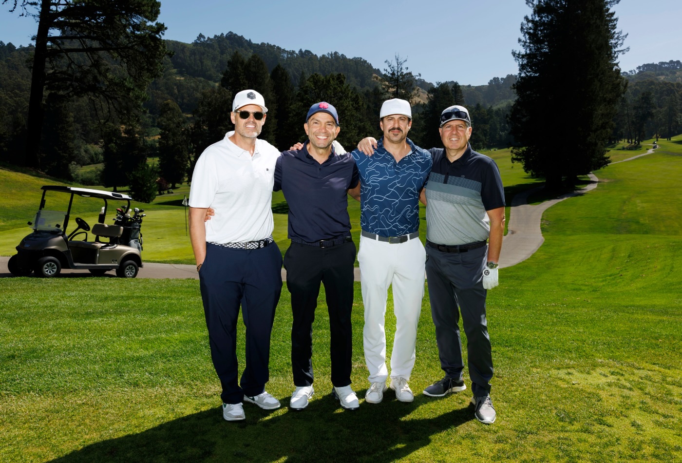 four men playing golf